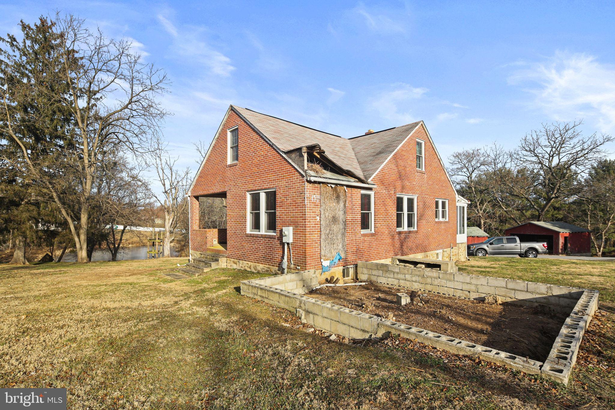 11850 Ramsburg Road Marriottsville, MD 21104 - Photo 40 of 49 a view of a white house with a yard next to a road