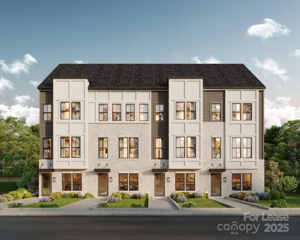 a front view of a residential apartment building with a yard