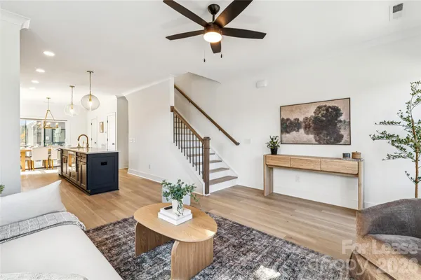 a living room with furniture and a potted plant
