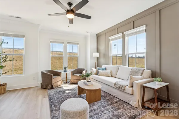 a living room with furniture and a large window