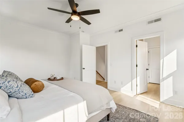 a bedroom with a bed and a mirror