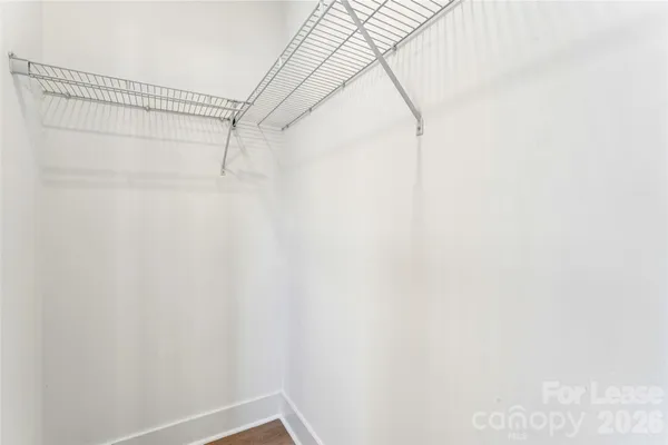 an empty room with a window and a ceiling fan