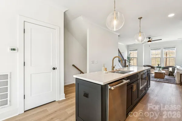 a kitchen with stainless steel appliances granite countertop a sink a stove and a refrigerator