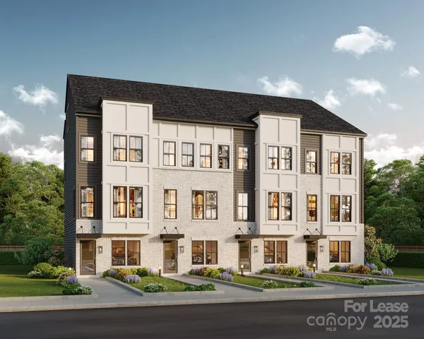 a living room with furniture and large windows