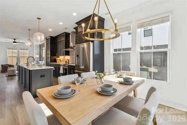 a kitchen with stainless steel appliances granite countertop a sink a stove and a refrigerator