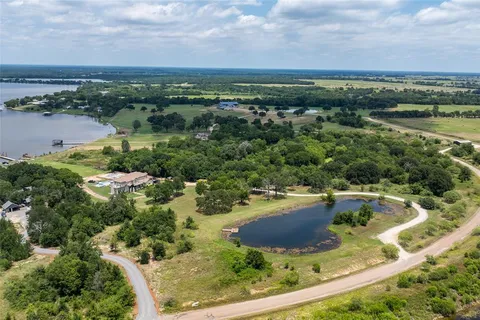 a view of a swimming pool with a yard and outdoor seating
