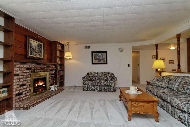 1702 Fitzgerald Road Simi Valley, CA 93065 - Photo 8 of 12 a living room with furniture and a fireplace