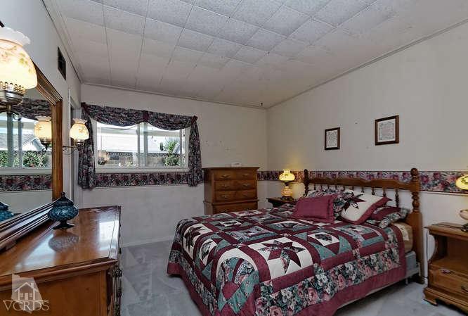 1702 Fitzgerald Road Simi Valley, CA 93065 - Photo 9 of 12 a bedroom with a bed and glass door