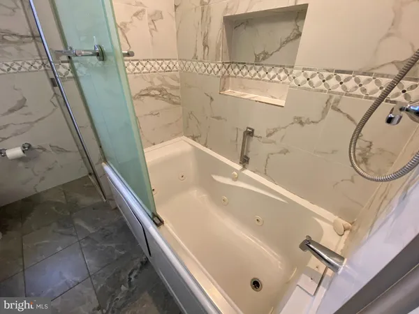 a bathroom with a bathtub and shower