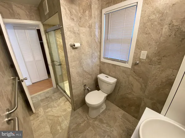 a bathroom with a toilet and a shower