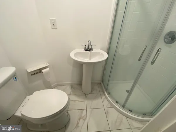 a bathroom with a sink toilet and a mirror