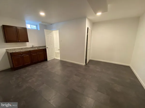 a kitchen with granite countertop a refrigerator and a stove top oven