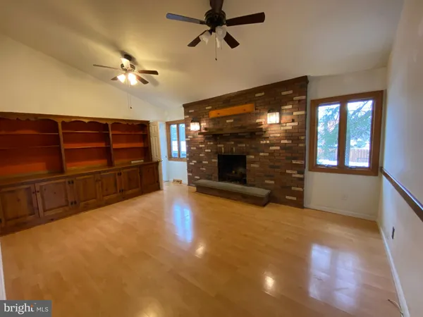 a view of a livingroom with a fireplace and window