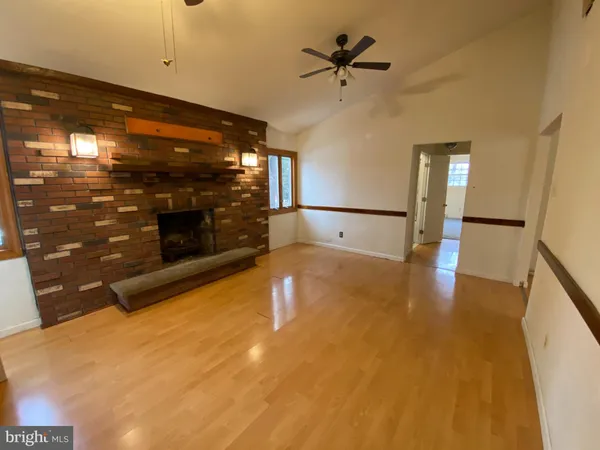 a view of an empty room with a fireplace