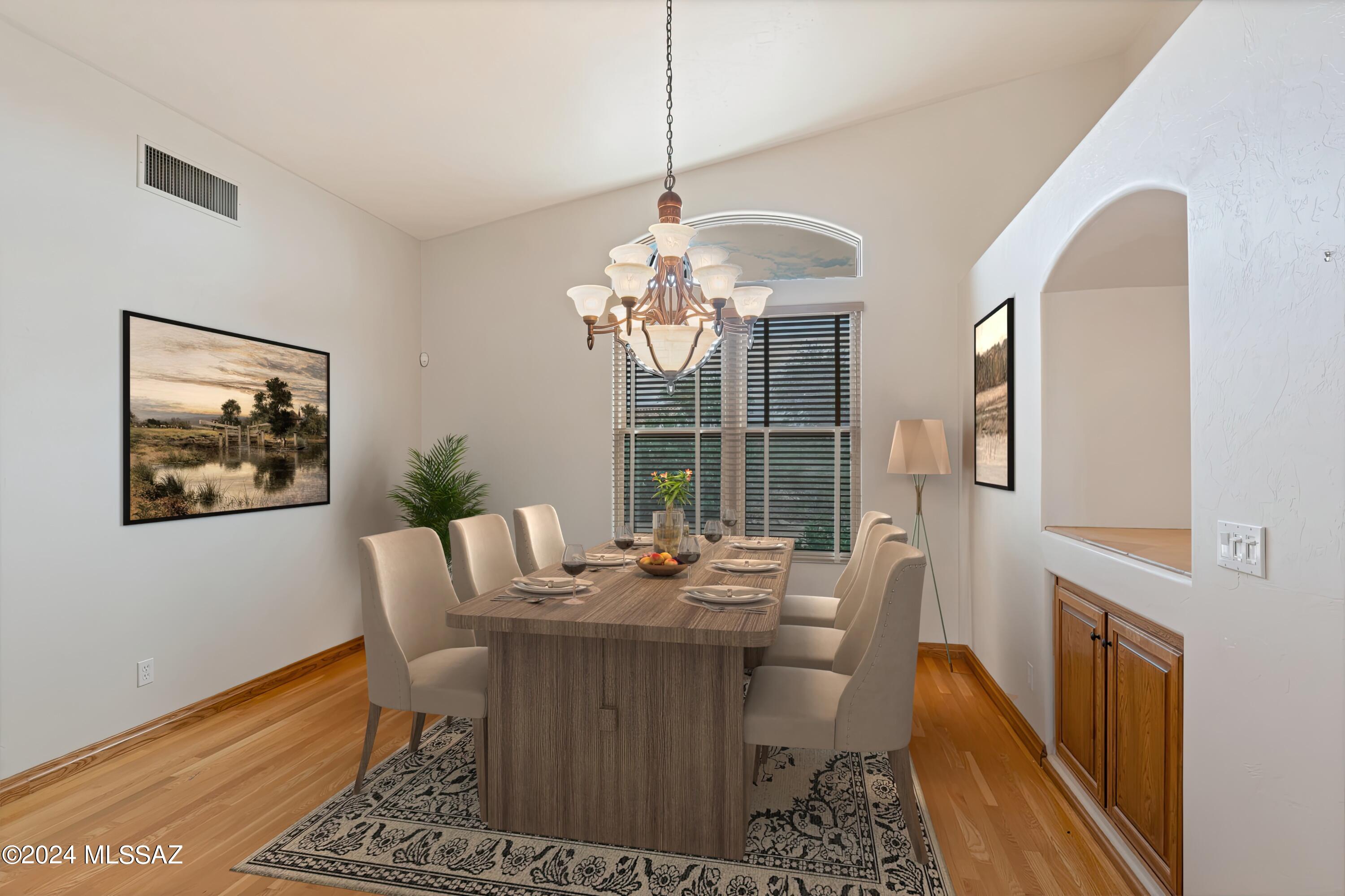 4001 North Harrison Road Tucson, AZ 85749 - Photo 22 of 50 a dining room with furniture a rug and a chandelier
