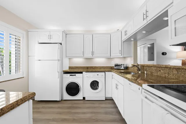 a kitchen with kitchen island a stove a sink and a refrigerator