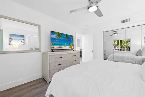 a bedroom with a bed and a flat screen tv