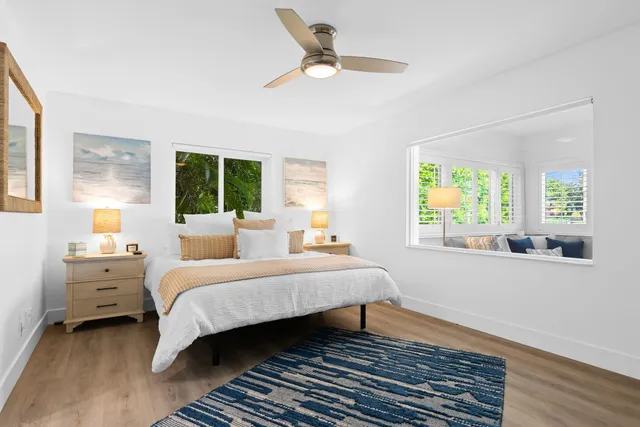 a bedroom with a bed and a large window