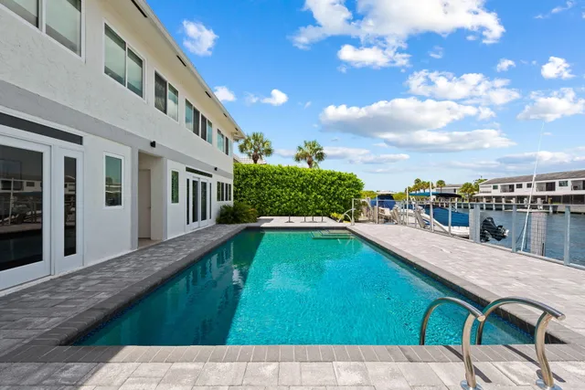 a view of swimming pool with a lounge chairs