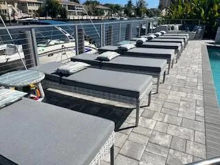 a roof deck with barbeque and outdoor seating