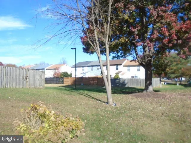 a view of a yard with a house in the background