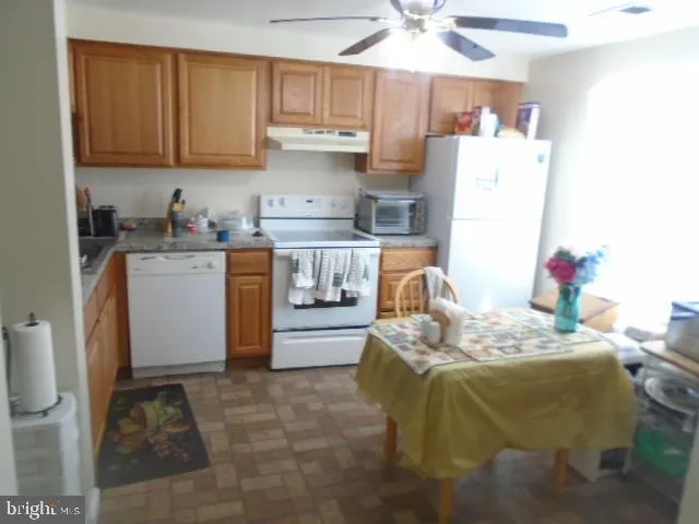 a bed room with a bed and a refrigerator