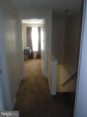 a view of a hallway view with staircase