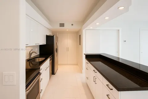 a kitchen with granite countertop cabinets and steel stainless steel appliances