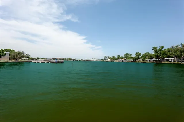 a view of a large trees with wooden fence