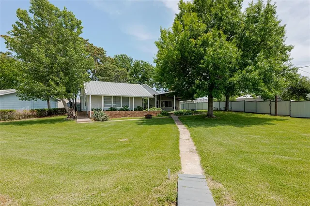 a front view of house with yard and trees