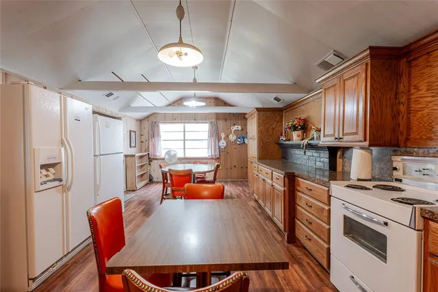 a bed sitting in a spacious bedroom next to a window