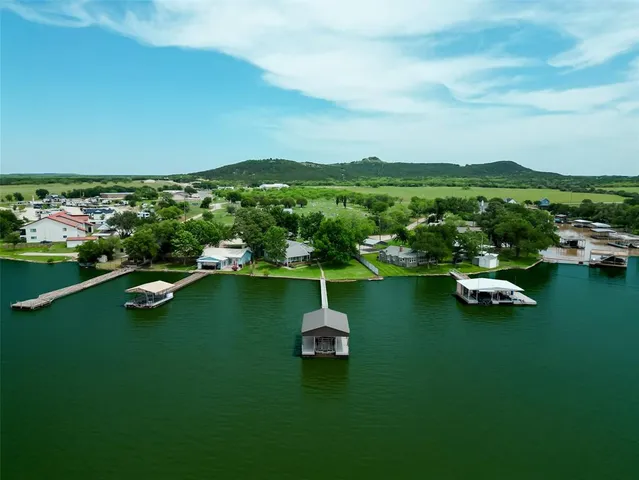 an aerial view of residential houses with outdoor space and street view