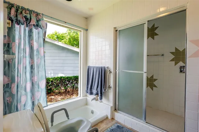 a bed sitting in a spacious bedroom next to a window