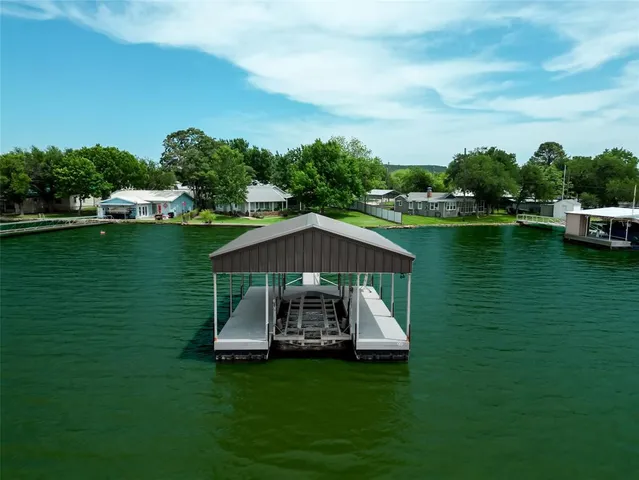 a view of a chair and table on the green field