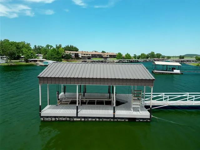 a view of a swimming pool and lounge chairs in the patio