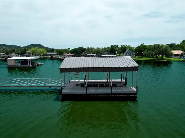 an aerial view of green landscape with trees houses and mountain view
