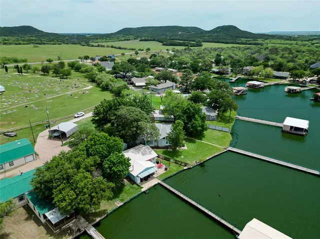 an aerial view of lake residential houses with outdoor space and trees