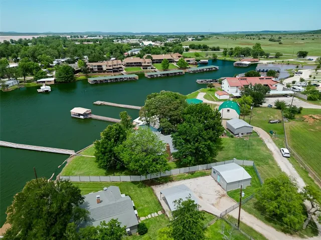 an aerial view of a house with a lake view