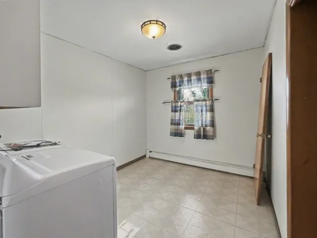 a view of storage and utility room with window