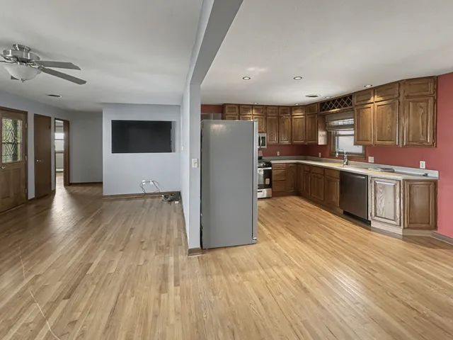 a kitchen with stainless steel appliances granite countertop a stove and a refrigerator
