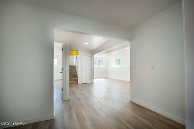 a view of a hallway with wooden floor