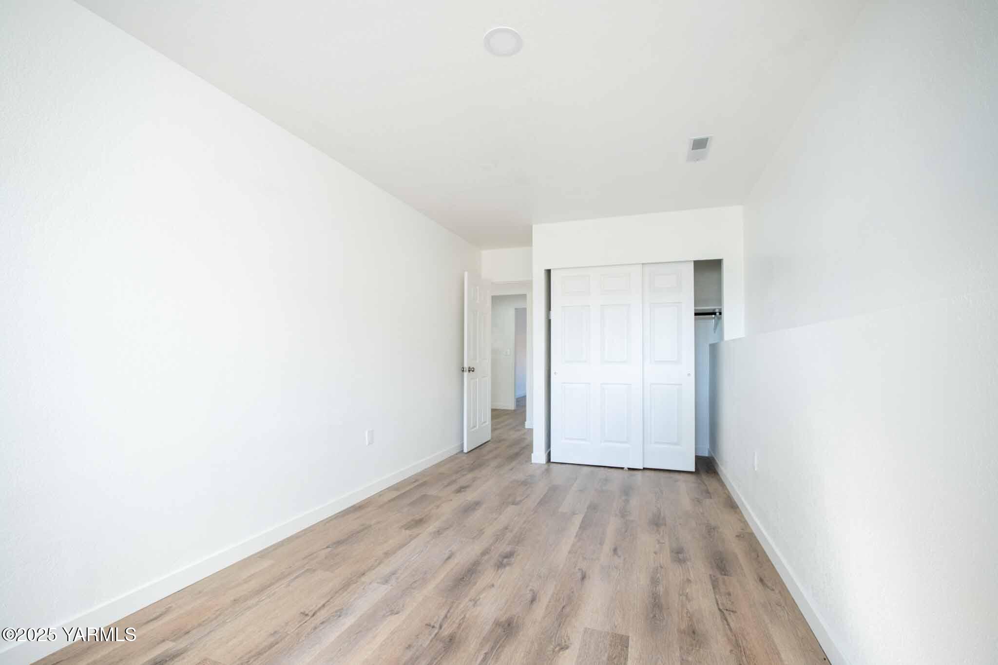 4711 Carol Avenue Yakima, WA 98908 - Photo 19 of 28 a view of an empty room with wooden floor