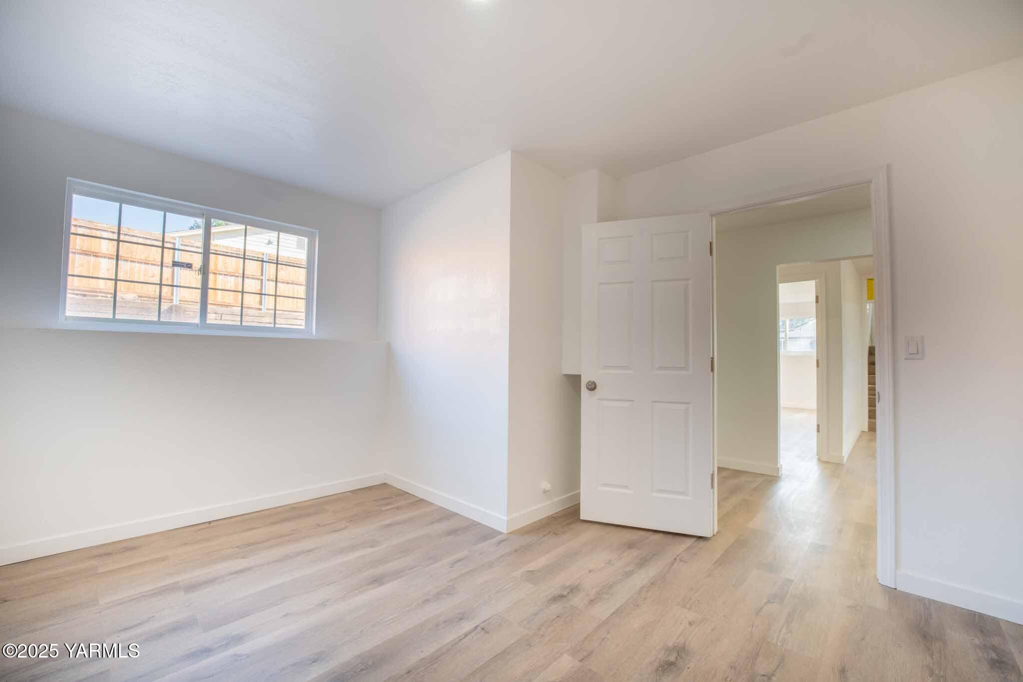 4711 Carol Avenue Yakima, WA 98908 - Photo 20 of 28 a view of an empty room with wooden floor and a window