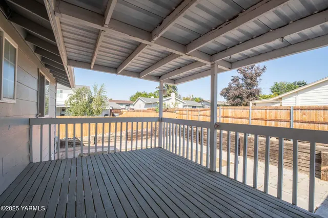 a view of a balcony with wooden floor