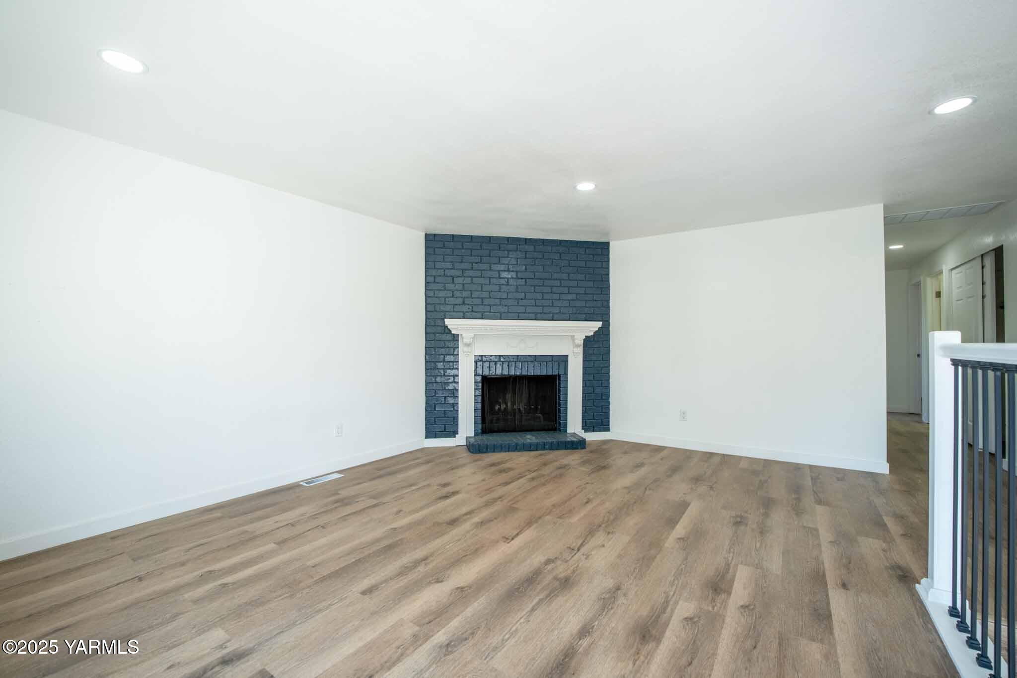 4711 Carol Avenue Yakima, WA 98908 - Photo 5 of 28 a view of an empty room with a fireplace and a window
