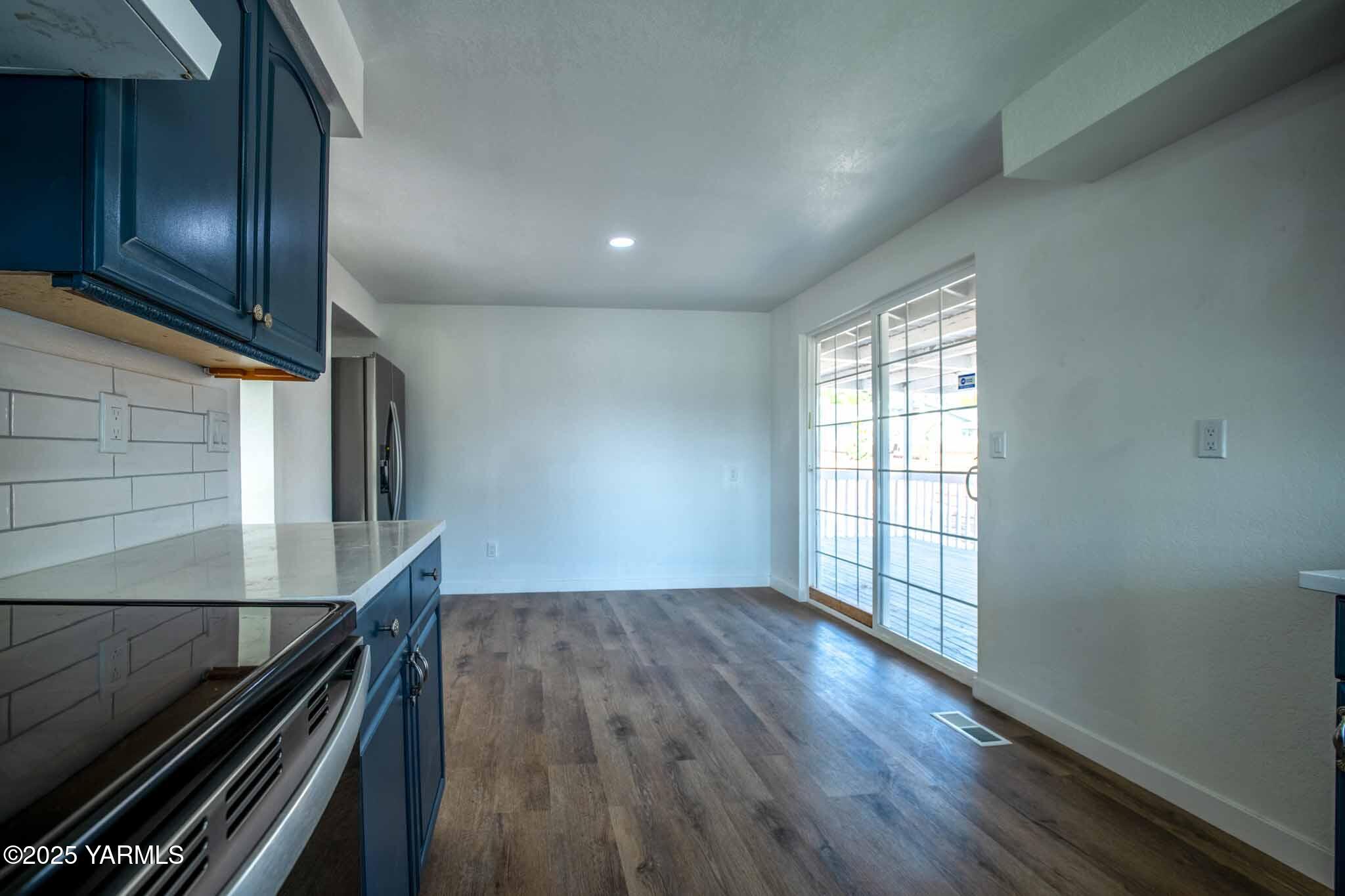 4711 Carol Avenue Yakima, WA 98908 - Photo 8 of 28 a view of an empty room with wooden floor and a window