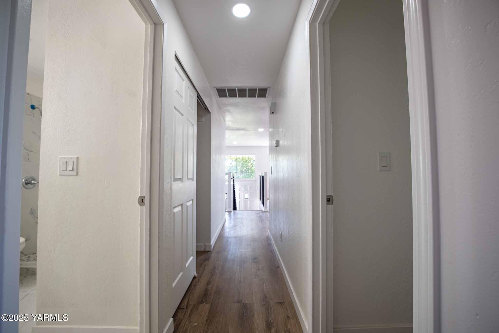 4711 Carol Avenue Yakima, WA 98908 - Photo 9 of 28 a view of a hallway with wooden floor and staircase