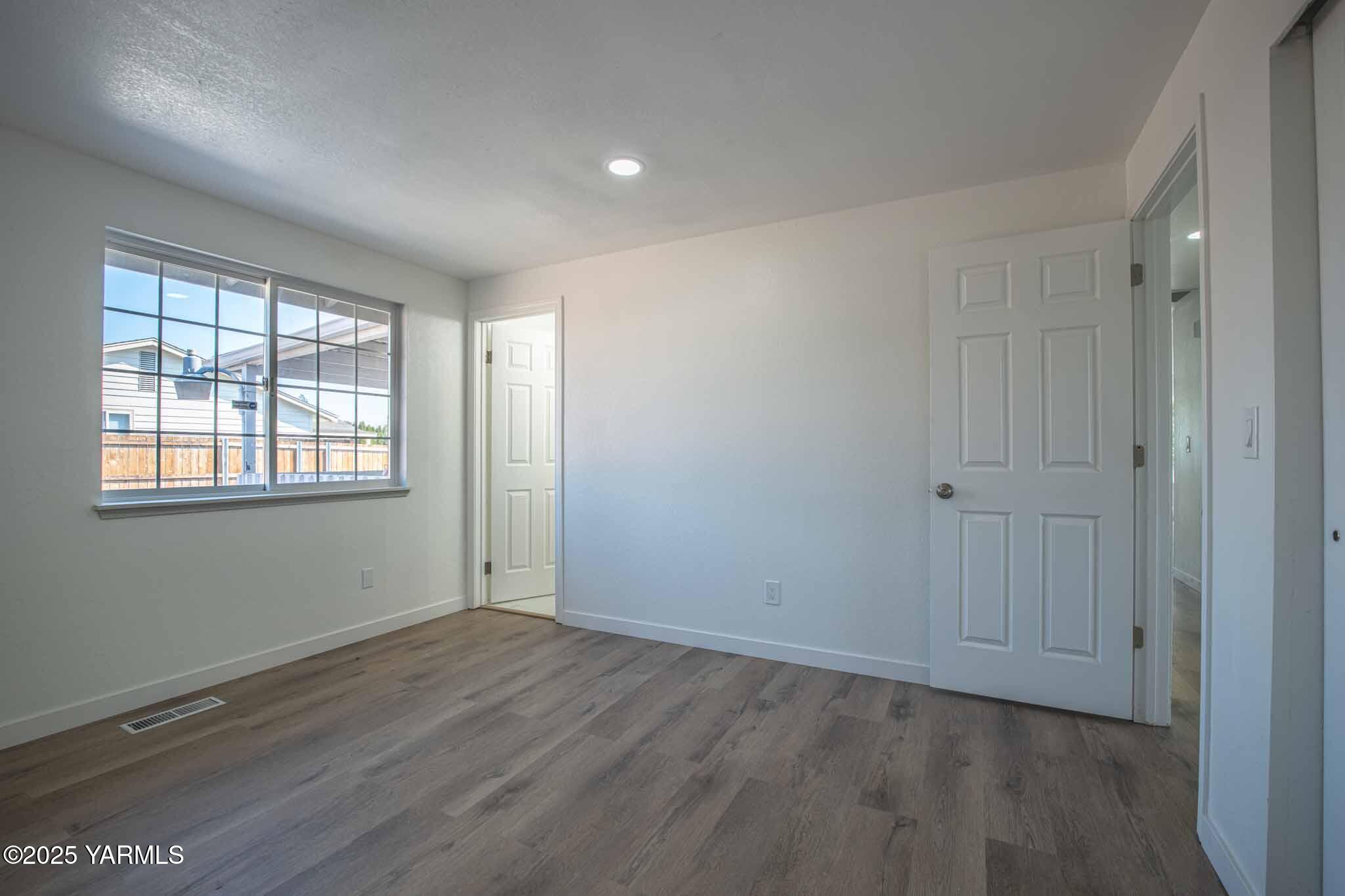 4711 Carol Avenue Yakima, WA 98908 - Photo 10 of 28 an empty room with wooden floor and windows