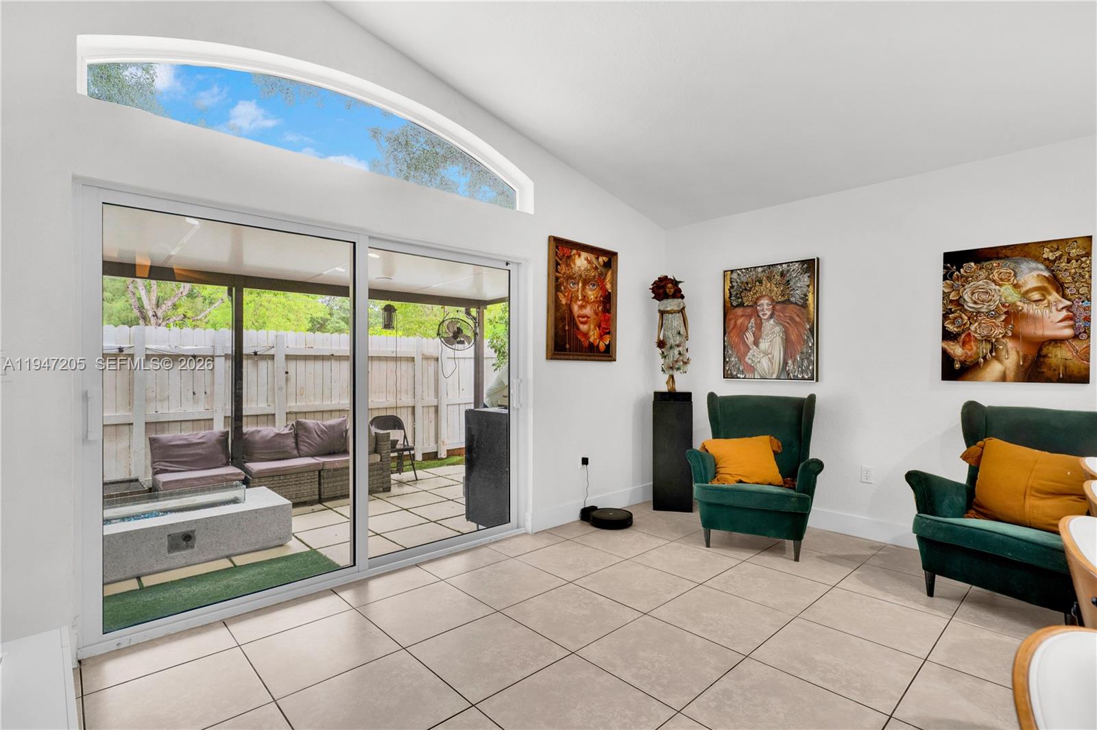 a living room with furniture and a floor to ceiling window