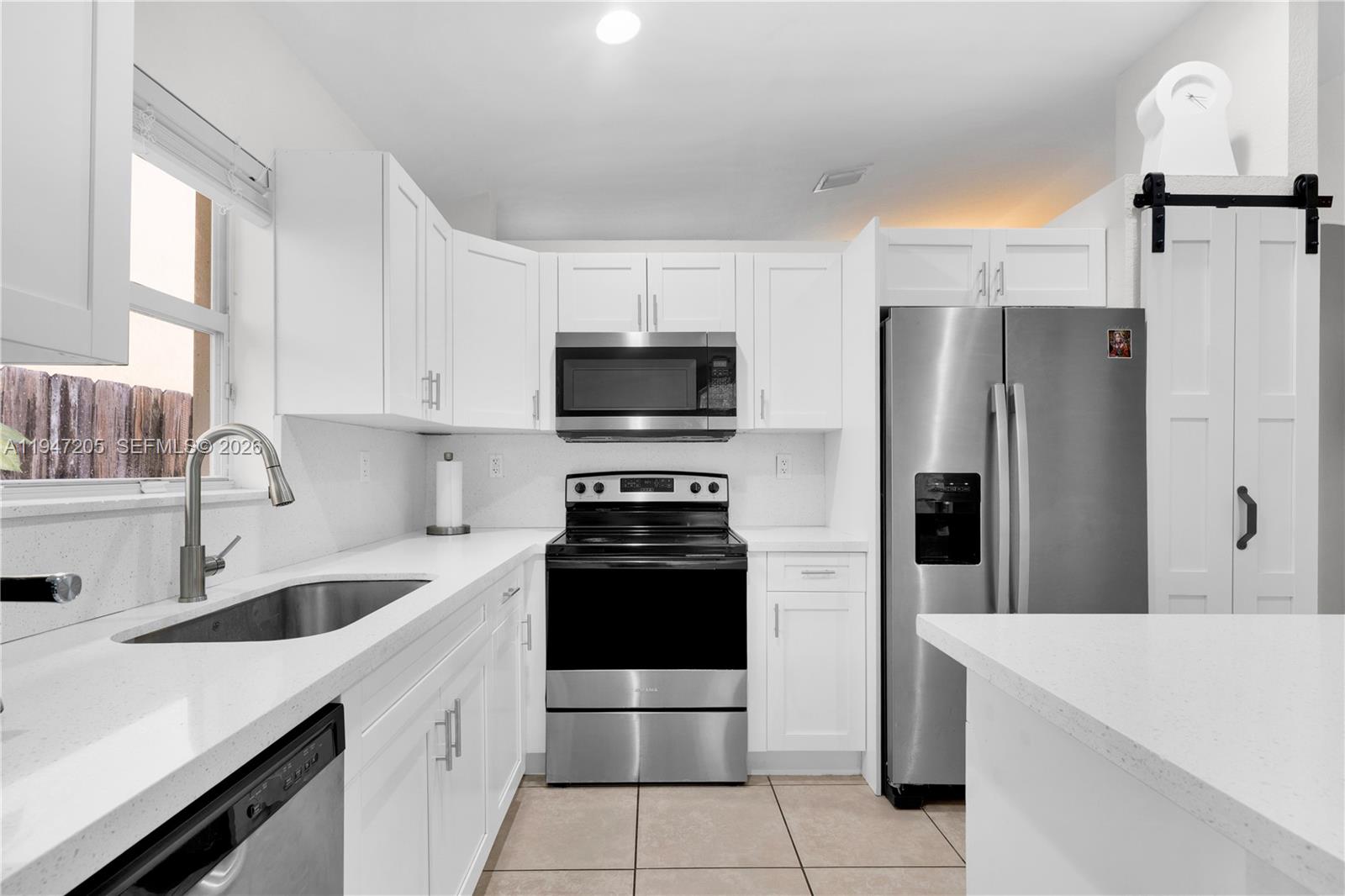 1959 Southeast 10th Street Homestead, FL 33035 - Photo 11 of 39 a kitchen with a sink stove and refrigerator